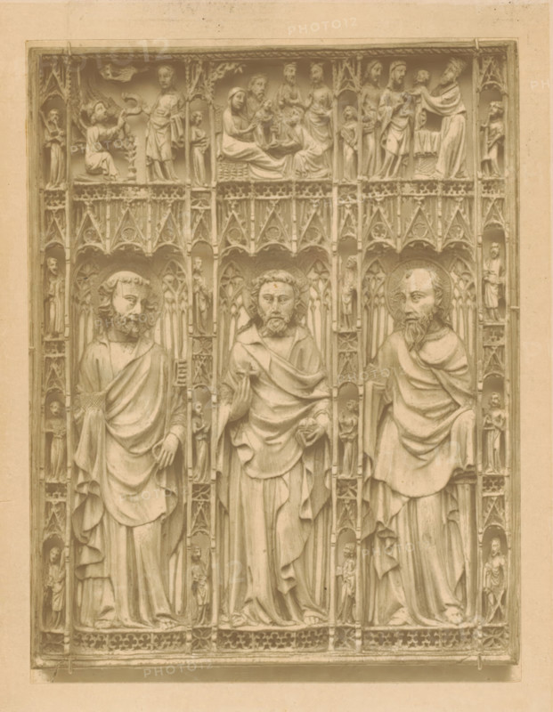 Panel. probably of a casket, page, photomechanical print, inscription: 'Fourteenth Century', number: 'No. 213-65.', London, c. 1867 - in or before 1872, paper, Woodburytype, height 148 mm x width 112 mm, (single) apostle, unspecified, Christ, sculpture (relief, sculpture), A carved stone panel framed by a rectangular border shows three tall standing figures in long draped robes with bearded faces and haloed heads occupying central vertical niches, each figure holding different hand gestures or objects; ornate tracery and small sculpted figures fill the vertical spaces between and beside the main figures, while a horizontal band above contains a series of smaller relief scenes depicting seated and standing figures interacting within architectural niches; the entire surface has a uniform aged stone tone and fine carved details in the garments, hair, and decorative Gothic-style arches and patterns.