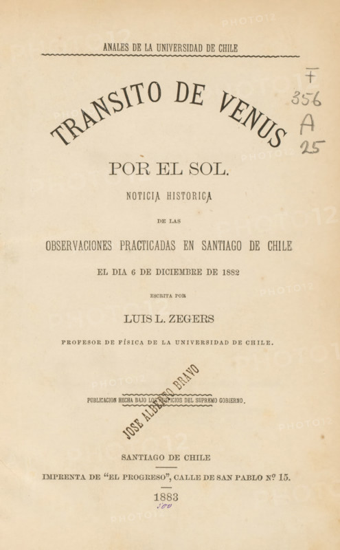 Transito de Venus por el sol, book, writer (clerical worker): Luis L. Zegers, publisher: El Progreso, Santiago de Chile, 1883, writer (clerical worker), pasteboard, biological material, paper, leather, printing, albumen print, veined marbled paper, agate marbled paper, color on cut, height 235 mm x width 162 mm x thickness 24 mm, A vertically oriented aged paper page with printed typographic elements arranged in centered lines, featuring a large arched headline near the top, narrower lines of type beneath, a circular diagonal stamped name across the middle, a narrow decorative wavy rule, and a column of small handwritten pencil marks near the right margin; the paper shows a warm beige tone with darker age spots and light edge discoloration.