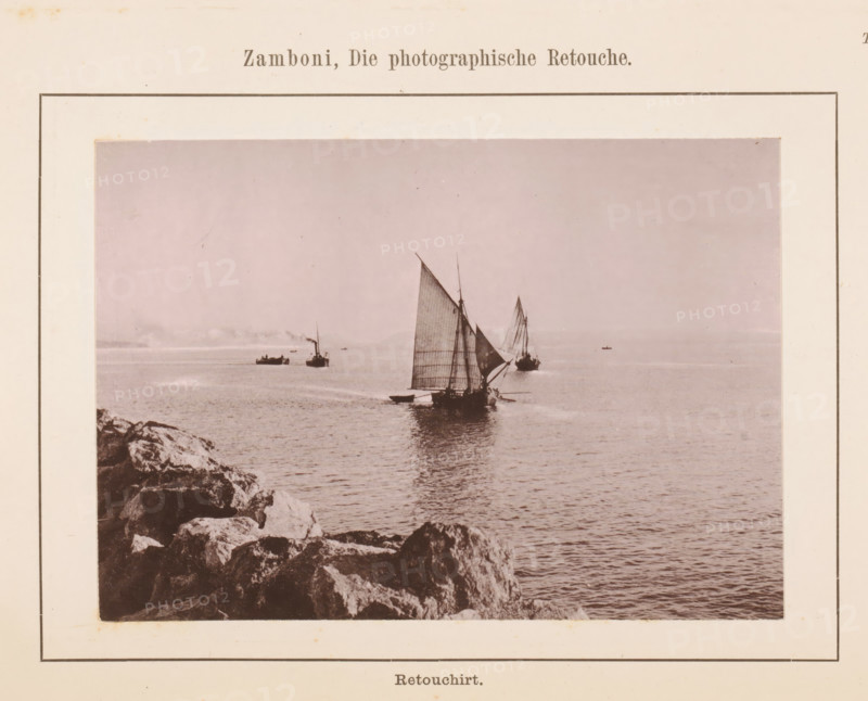 View of a boat along a coast, page, photomechanical print, number: 'Tafel IX.', inscription: 'Retouchirt.', c. 1878 - in or before 1888, paper, collotype, photoprint, height 118 mm x width 181 mm, ships (in general), sea, A sepia-toned photograph mounted on a bordered page shows a rocky shoreline in the foreground and a calm sea extending to the horizon, with several sailboats and a steamboat visible on the water, sails raised and reflections on the surface, distant small vessels near the horizon, and the photograph surrounded by a wide light-colored margin.