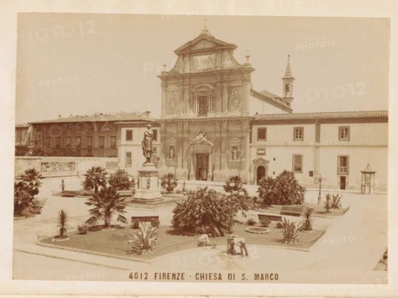 The monastery of San Marco, book, inscription: 'ex libris SFJ', inscription: 'G Giannini books binder Florence Piazza Pitti 19.20.', writer (clerical worker): Georgina Sarah Godkin, publisher: G. Barbèra, Florence, 1890, writer (clerical worker), Tuscany, pasteboard, parchment (animal material), biological material, paper, vellum (parchment), printing, albumen print, color on cut, height 185 mm x width 130 mm x thickness 17 mm, A sepia photograph shows a classical church façade with ornate architectural details, a central entrance framed by columns and niches containing statues, a triangular pediment at the top, and a bell tower with a spire visible to the right; in front of the church a raised square contains a statue of a robed figure on a pedestal surrounded by a low fence and planted beds with palms and other shrubs, pathways, lamp posts, and a small fountain where a person leans over; adjoining buildings with rectangular windows flank the church and a longer block of buildings str...