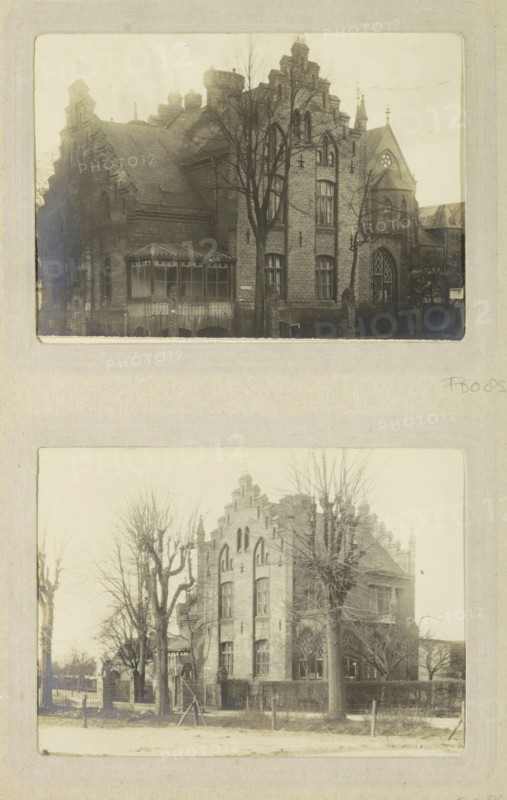 Exterior of the director's residence of Oslebshausen prison, photograph, postcard, Part of Photo album of Carl Heinrich Fliegenschmidt, prison director in Oslebshausen., Oslebshausen, 1890 - 1910, photographer, Bremen (city), paper, gelatin silver print, developed gelatin silver print, height 78 mm x width 110 mm, rural housing, eg country-house, villa, cottage, façade (of house or building), prison, jail, A faded photograph shows a large brick building with ornate gables and arched windows, a tall bare tree in front partially obscuring the facade, a small enclosed porch with a multi-paneled roof attached to one side, pointed rooflines and decorative stonework, a wrought iron fence and low brick wall at the sidewalk, leafless trees lining the street, and a second similar photograph of the same building below, all mounted on a pale scrapbook page.