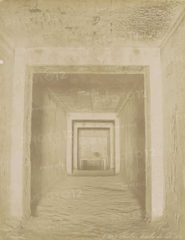Thebes tomb de roi N. 9, Tomb of Ramses V and VI (KV9) in the Valley of the Kings, Thebes (Luxor), Burial chamber of an Egyptian pharaoh in Thebes (former title), photograph, Part of Travel album with 80 photos of Egypt., negative number: '941', photographer: Zangaki, C. & G., c. 1870 - c. 1890, North Africa, Upper Egypt, pasteboard, paper, albumen print, height 278 mm x width 219 mm, grave, tomb, Luxor, A narrow stone passage framed by a series of rectangular doorways receding into the distance, with textured walls and a rough floor, a ceiling showing uneven patches and marks, shallow reliefs and carvings visible on the side walls near the openings, and a muted monochrome tone across the entire scene.