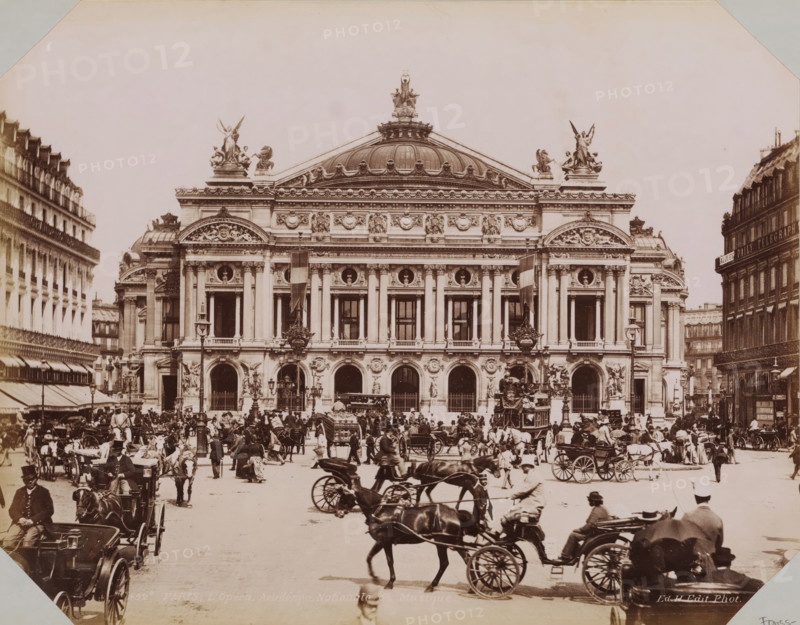 View of the Opéra de Paris, album cover, photograph, This photo is part of an album., retailer's mark: 'E. Hautecoeur, Estampes Photographies, 35 Avenue de l'Opéra, 35, Paris', inscription: '452c. Paris, L'Opéra, Academie de Nationale de Musique. Ed. H.Edit. Phot.', photographer: Edouard Hautecoer, Paris, publisher: Edouard Hautecoer, 1890 - 1898, Edouard Hautecoer, photographer, publisher, paper, albumen print, albumendruk, height 258 mm x width 355 mm, square, circus, etc. (city(-scape) with figures, staffage), opera house, Opéra de Paris, A wide stone building with a domed roof and ornate sculptures along its cornice fills the center of the image, its facade featuring tall columns, rounded arches at street level, decorative circular reliefs, and carved figures above windows. Two large sculpted winged figures sit atop pedestals at the outer corners of the roofline while a central sculptural group crowns the dome. In front of the building a busy street scene shows many horse-drawn car...