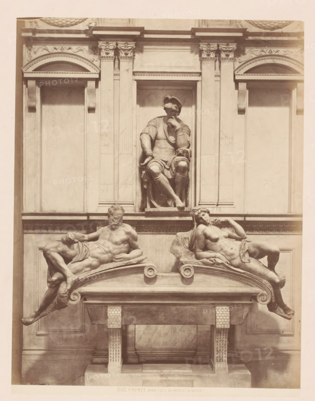 Tomb monument for Lorenzo de' Medici in the Medici Chapel in Florence, Italy, Mont. di L. De Medici di Mich., Firenze, photograph, address: 'GIACOMO BROGI, FOTOGRAFO-EDITORE, FIRENZE, LUNG ARNO DELLE GRAZIE 15', number: '3102.', photographer: Giacomo Brogi, Florence, publisher: Edizioni Brogi, after sculpture by Michelangelo, 1864 - 1881, Giacomo Brogi, Edizioni Brogi, Michelangelo, photographer, publisher, after sculpture by, Tuscany, pasteboard, paper, albumen print, albumendruk, height 470 mm x width 350 mm, Person, Lorenzo de' Medici, piece of sculpture, reproduction of a piece of sculpture, grave-building, monumental tomb, Cappelle Medicee, A stone architectural facade with a central recessed niche containing a seated male figure wearing a draped garment and a head covering, one hand resting on his chin and the other on his knee, flanked by vertical pilasters and decorative molding; below, a horizontal entablature supports two reclining nude figures on curved ledges, one male on t...