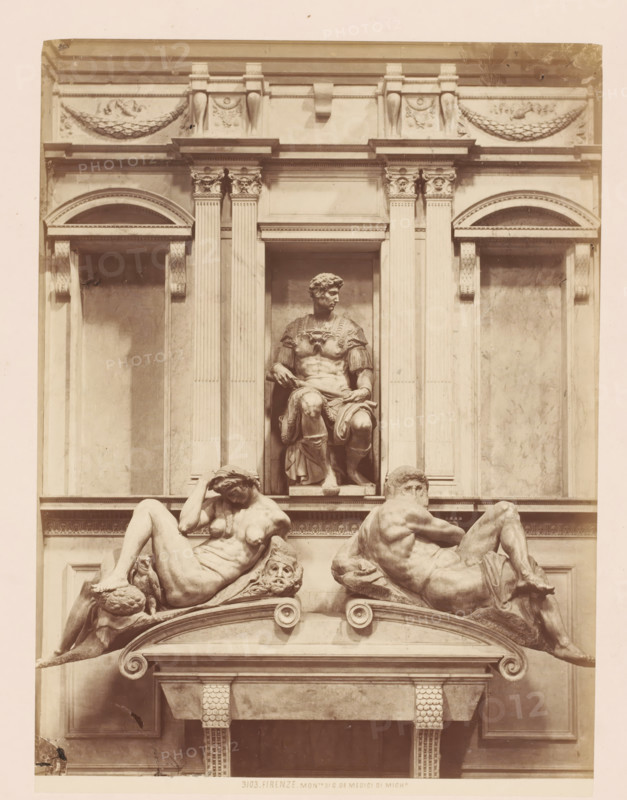 Monto. di G. de Medici di Mich, Funerary monument for Giuliano de' Medici after Michelangelo in Florence, Italy, Firenze, photograph, number: '3103.', address: 'GIACOMO BROGI, PHOTOGRAPHEDITORE, FIRENZE, LUNG ARNO DELLE GRAZIE 15', photographer: Giacomo Brogi, Florence, publisher: Edizioni Brogi, after sculpture by Michelangelo, 1864 - 1881, Giacomo Brogi, Edizioni Brogi, Michelangelo, photographer, publisher, after sculpture by, Tuscany, pasteboard, paper, albumen print, height 471 mm x width 350 mm, Person, Giuliano de' Medici, piece of sculpture, reproduction of a piece of sculpture, grave-building, monumental tomb, Cappelle Medicee, A stone architectural façade with fluted columns and decorative capitals framing a recessed niche that contains a seated male statue wearing a draped garment and armor, below which two reclining nude figures lie on a curved ledge, one leaning on an ornamental head and the other turned to the side, all carved in a classical sculptural style with carved w...
