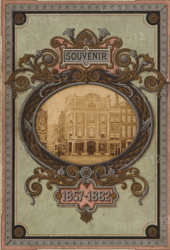 Corner building in Amsterdam, presumably belonging to Hendrik Willem Nijman and Catharina Maria Beijer, photograph, Amsterdam, c. 1877 - in or before 1882, photographer, paper, albumen print, height 74 mm x width 94 mm, Photo on front cover., façade (of house or building), An ornate rectangular design with a muted green background and layered decorative borders in pink, gray, and black surrounds an oval frame featuring a sepia-toned photograph of a multi-story classical building with arched windows and storefronts at street level; the oval frame is embellished with scrolling acanthus leaves, floral motifs, and ribbon-like patterns in gold, brown, and gray, with additional stylized floral and scroll decorations above and below the frame.