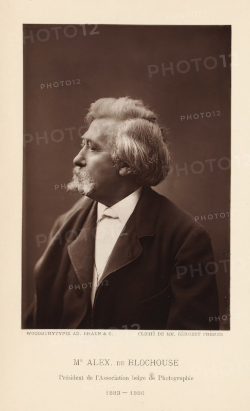 Mr Alex. de Blochouse, Président de l'Association belge de Photographie 1883-1886, Portrait of Alexandre de Blochouse, president of the Association belge de Photographie, page, photomechanical print, photographer: Géruzet Frères, cliché maker: Adolphe Braun & Cie., printer (person): Adolphe Braun & Cie., Dornach, 1883 - 1886, Géruzet Frères, Adolphe Braun & Cie., photographer, cliché maker, printer (person), Mulhouse, paper, Woodburytype, Woodburytypepie, height 147 mm x width 100 mm, Print on unnumbered page., Person, Alexandre de Blochouse, historical persons, adult man, chairman, A sepia portrait of an older man shown in profile facing left, with wavy light hair and prominent sideburns and a mustache, wearing a dark jacket over a light shirt and a high collar, set against a plain dark background and framed by a light border.
