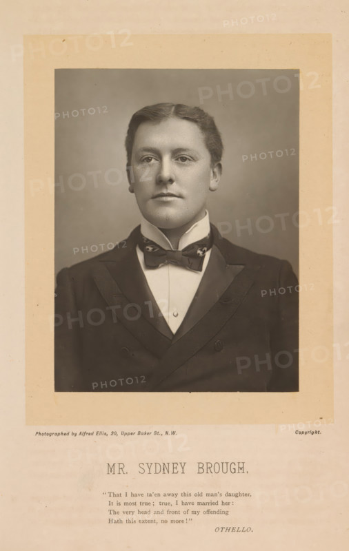 Portrait of Sydney Brough, Mr. Sydney Brough, photograph, page, inscription: ''The Theater' February, 1894.', inscription: ''That I have taén away this old man's daughter, ', photographer: Alfred Ellis, 1885 - 1894, paper, carbon print, height 117 mm x width 88 mm, Person, Sydney Brough, historical persons, A sepia-toned portrait of a young man shown from the chest up, mounted on a beige mat. He has short, neatly combed hair and a smooth, clean-shaven face with a neutral expression and direct gaze. He wears a high-collared shirt with a bow tie and a dark double-breasted jacket with satin lapels. The background behind him is plain and softly shaded. The mounting shows a wider border around the portrait with faint marks and aging spots.