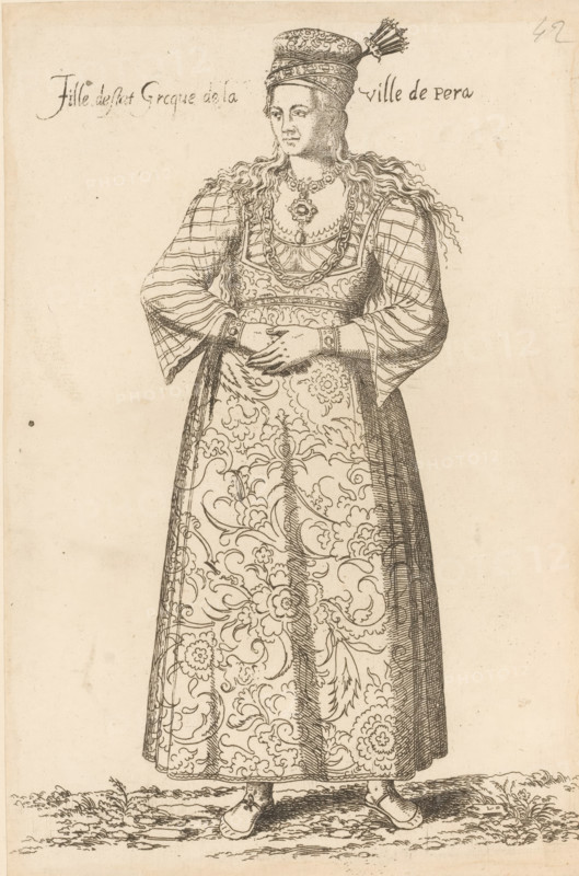 Greek girl, from Péra, Fille d'estat grecque de la ville de Péra, print, album page, book illustration, Print is part of an album., printmaker: Léon Davet, after drawing by Luca Penni (attributed to), after drawing by Nicolas de Nicolay (possibly), publisher: Guillaume Rouille (I), Lyon, 1555 - 1568, Léon Davent, Luca Penni, Nicolas de Nicolay, Guillaume Rouille (I), printmaker, publisher, Attributed to, paper, etching, mounted on album page, height 261 mm x width 174 mm, A standing woman is shown in a long patterned dress with swirling floral designs, wearing a long-sleeved outer garment with a checked pattern on the sleeves and a decorative bodice; she has long wavy hair falling over her shoulders, a tall ornate hat with a plume, layered necklaces and a pendant, bracelets at her wrists, hands clasped at her waist, simple pointed shoes, and she stands on a patch of ground with tufts of grass.