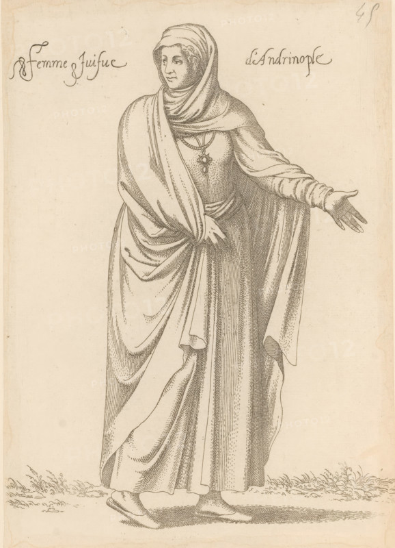 Jewish woman from Andrinople or Edirne in Thrace, Femme juifve d'Andrinople, print, album page, book illustration, Print is part of an album., printmaker: Léon Davet, after drawing by Luca Penni (attributed to), after drawing by Nicolas de Nicolay (possibly), publisher: Guillaume Rouille (I), Lyon, 1555 - 1568, Léon Davent, Luca Penni, Nicolas de Nicolay, Guillaume Rouille (I), printmaker, publisher, Attributed to, paper, etching, pasted on album page, height 245 mm x width 175 mm, A finely detailed line drawing of a standing woman wearing a headscarf and long layered draped garments that cover her body and arms, one hand extended outward with fingers spread and the other hand resting near her waist holding the drapery, a pendant hanging at her chest, visible folds and textures in the fabric, simple flat shoes on her feet, and a suggestion of ground and small plants at the bottom edge.