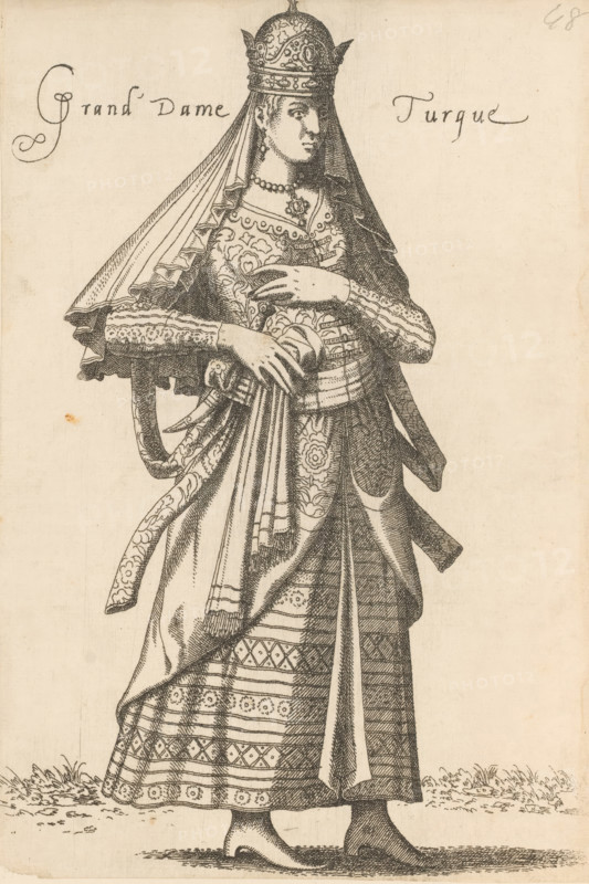 Turkish noblewoman, Grand Dame Turque, print, album cover, book illustration, Print is part of an album., printmaker: Léon Davent, after drawing by Luca Penni (attributed to), after drawing by Nicolas de Nicolay (possibly), publisher: Guillaume Rouille (I), Lyon, 1555 - 1568, Léon Davet, Attributed to, paper, etching, mounted on album page, height 258 mm x width 174 mm, A tall woman stands facing slightly to the side wearing an ornate headdress with pointed details and a long veil that drapes over her shoulders, a decorative necklace and earrings visible at her neck, and a richly patterned gown with layered sleeves, embroidered bodice, and a wrapped sash tied at her waist; her hands are clasped at her midsection, one resting over the other, and the skirt shows repeated geometric and floral bands that reach down to simple pointed shoes standing on a textured ground, with short tufts of grass near the hem.
