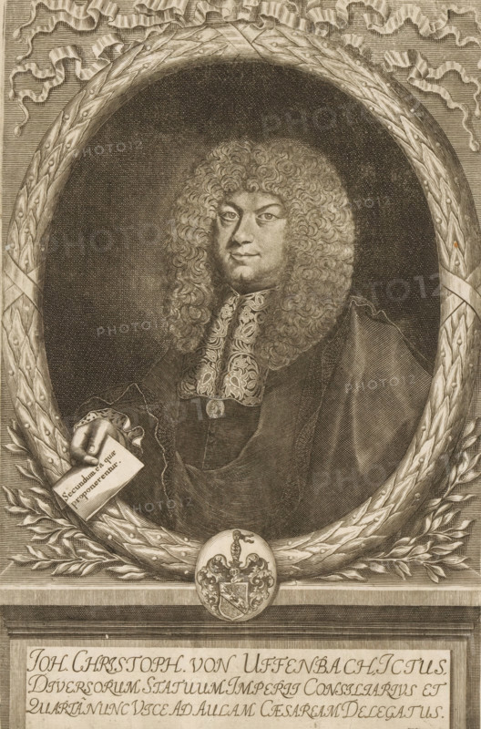 Portrait of Johann Christoph von Uffenbach, print, printmaker: Matthias van Sommer, Germany, 1643 - 1672, paper, engraving, etching, intaglio printmaking technique, height 290 mm x width 190 mm, Print used for: Uffenbach, Johann Christoph von. Illustrissimorum Comitum. Vienna and Prague: 1700., Person, Johann Christoph von Uffenbach, historical persons, armorial bearing, heraldry, A detailed engraved portrait shows a man with a voluminous curly wig and a composed facial expression, dressed in ornate formal clothing with an embroidered collar and a dark cloak; he is depicted within an oval leafy wreath with ribbon accents, one hand emerging to hold a rectangular card, and a decorative oval medallion with a heraldic shield rests at the base of the wreath, all rendered in fine crosshatching and stippled shading.