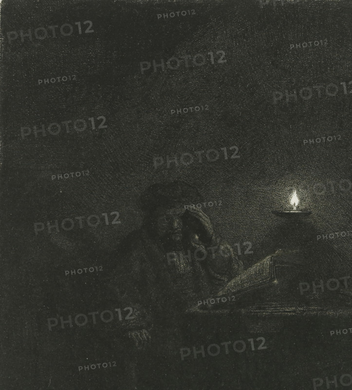 Student at a Table by the Light of an Oil Lamp, Student at a table by candlelight, print, signature: 'Rembrandt', printmaker: Rembrandt van Rijn, c. 1642, paper, etching, height 146 mm x width 133 mm, A dark, grainy scene with a textured background and a small bright flame on the right above a shallow dish, and a dimly visible figure seated near the flame holding an open book.