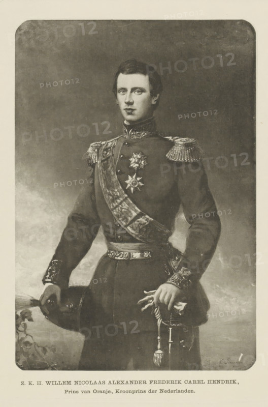 Portrait of William, Prince of the Netherlands, photomechanical print, Portrait of William. A line of Dutch text in the top margin. In the bottom margin are the name and titles., cliché maker: Emrik & Binger, Haarlem, after painting by Nicolaas Pieneman, publisher: Cohen, E. & M., Nijmegen, Arnhem, 1860 - 1903, photographer, paper, collotype, photoprint, height 237 mm x width 167 mm, The title mentioned here refers to the highest title obtained by the person portrayed, not necessarily to the title that the person portrayed bears in this performance., Person, Willem (Prince of the Netherlands), A monochrome portrait of a young man standing and facing forward, wearing a dark formal military-style uniform with decorative epaulettes, embroidered cuffs, and a high collar; a broad ornate sash crosses his chest and a star-shaped medal is pinned on his left side; he holds a plumed hat in one hand and a ceremonial sword with tassel in the other, and his expression is neutral with short dark hai...