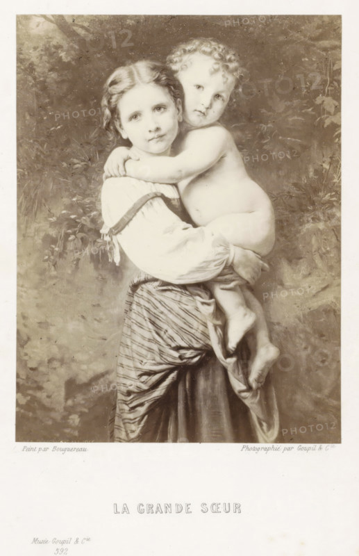 La grande sœur, Photo reproduction of the painting La grande sœur, reproduction, page, photomechanical print, name: 'Goupil', photographer: Goupil & Cie., France, cliché maker: anonymous, after painting by William-Adolphe Bouguereau, Paris, in or after 1865 - in or before 1869, paper, Woodburytype, Woodburytypepie, height 121 mm x width 90 mm, girl (child between toddler and youth), child, A sepia-toned image of a young girl holding a naked toddler against her chest, the girl facing forward with a calm expression and the toddler resting an arm around her shoulders while looking outward, both with soft facial features and curly hair on the toddler; the girl wears a blouse with puffed sleeves and a striped skirt with draped fabric, and the toddler's legs hang down with visible feet; the background shows indistinct foliage and textured shading.