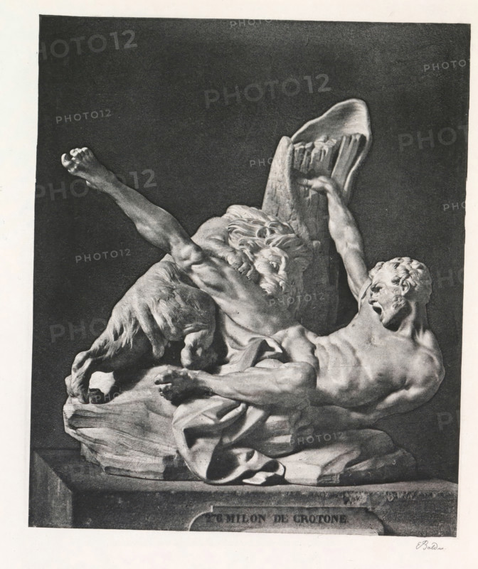Morceau de réception d'Étienne Falconet à l'Académie, 1754, Sculpture of Milos van Croton, page, photomechanical print, inscription: 'Musée du Louvre.', photographer: Édouard Denis Baldus, France, cliché maker: anonymous, c. 1859 - in or before 1869, paper, photoaquatint, height 192 mm x width 160 mm, Print after page 40., sculpture, wrestling (sport), A grayscale image of a sculptural relief showing two male figures and a goat-like animal on a rocky base against a dark rectangular background, one figure reclines with a muscular torso and outstretched arm while looking upward with an open mouth, the other figure appears older with a flowing beard and raised arm, the animal stands with its head lowered and legs visible, draped cloth folds cover part of the figures and base, and the composition rests on a plinth with a faint signature visible near the lower right corner.