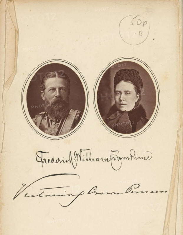 Double portrait of Emperor Frederick III of Prussia and Empress Victoria of Prussia, page, photomechanical print, inscription: 'Frederick William Crown Prince Victoria Crown Princess', c. 1883 - in or before 1888, paper, Woodburytype, Woodburytypie, height 191 mm x width 125 mm, Prints on frontispiece., Person, Victoria of Saxe-Coburg and Gotha (German Empress), Frederick III (King of Prussia and German Emperor), ruler, sovereign, sovereign - BB - female ruler, A yellowed page with signs of wear at the edges contains two oval sepia portrait photos near the top, each framed by double-lined borders; the left portrait shows a bearded man wearing a decorated uniform with a sash and medals, and the right portrait shows a woman wearing a dark textured hat and a fur-trimmed coat with a scarf.