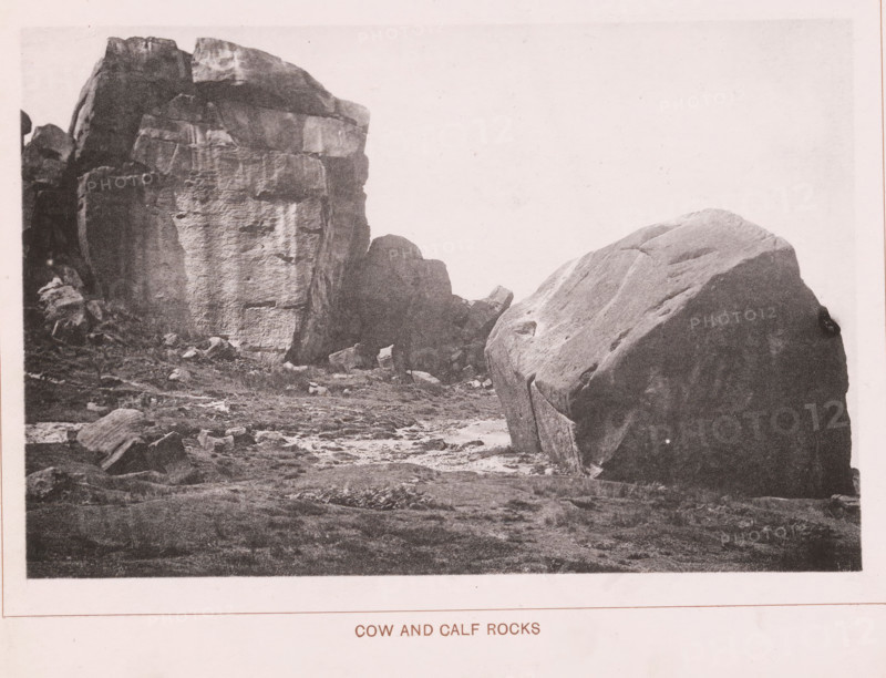 Cow and calf rocks, page, photomechanical print, c. 1890 - c. 1900, paper, collotype, photoprint, height 101 mm x width 153 mm, rock formations, A grayscale photograph showing a rocky landscape with a large, rounded boulder in the foreground on the right and a taller, layered rock formation on the left, with smaller rocks and uneven ground between them and a stretch of textured earth in the lower portion of the image.