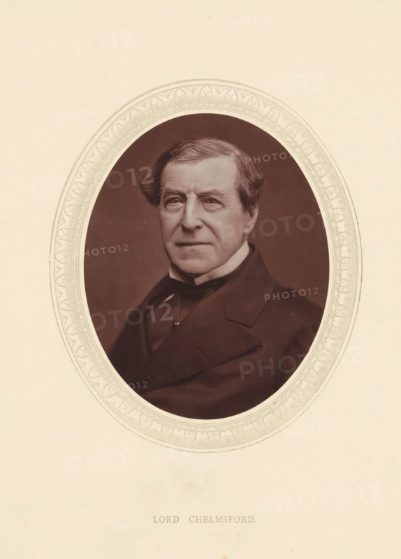 Lord Chelmsford, page, photomechanical print, photographer: Lock & Whitfield, cliché maker: anonymous, c. 1871 - in or before 1876, paper, Woodburytype, height 115 mm x width 89 mm, Person, Frederic Thesiger, politician, eg party leader, historical persons (portraits and scenes from the life) ((full) bust portrait), An oval portrait shows an older man from the chest up wearing a dark coat with wide lapels and a high-collared shirt, his hair swept to the side with gentle waves and a slightly receding hairline, and his face marked by fine lines and a neutral expression; the portrait is set against a plain dark background and surrounded by a decorative oval border with repeating leaf-like motifs, all on a light-colored paper.