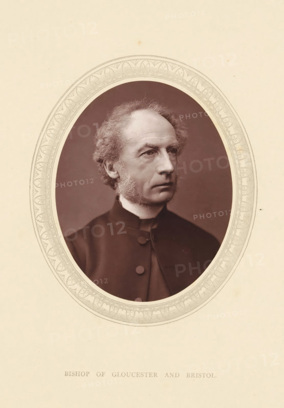 Bishop of Gloucester and Bristol, page, photomechanical print, photographer: Lock & Whitfield, cliché maker: anonymous, c. 1871 - in or before 1876, paper, Woodburytype, height 115 mm x width 89 mm, Person, Charles Ellicott, functionaries and dignitaries, episcopal Protestant churches, historical persons (portraits and scenes from the life) ((full) bust portrait), A sepia-toned oval portrait of an older man set against a decorative oval border on a light background, showing his head and upper torso turned slightly to one side with thinning, wavy hair and prominent sideburns, a high forehead, visible facial lines, and a composed expression; he wears a dark buttoned garment with a narrow white collar and the textured inner oval around him contrasts with the smooth outer background.