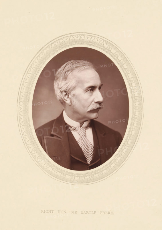 Right. hon. Sir Bartle Frere, page, photomechanical print, photographer: Lock & Whitfield, cliché maker: anonymous, c. 1871 - in or before 1876, paper, Woodburytype, height 115 mm x width 89 mm, Person, Henry Bartle Frere, colonial governor, historical persons (portraits and scenes from the life) ((full) bust portrait), An oval portrait of an older man in profile facing right, set against a plain vignette background and surrounded by an ornate decorative oval border, showing his light hair combed back, a prominent mustache, a high-collared shirt with a patterned necktie, and a dark suit jacket with lapels.