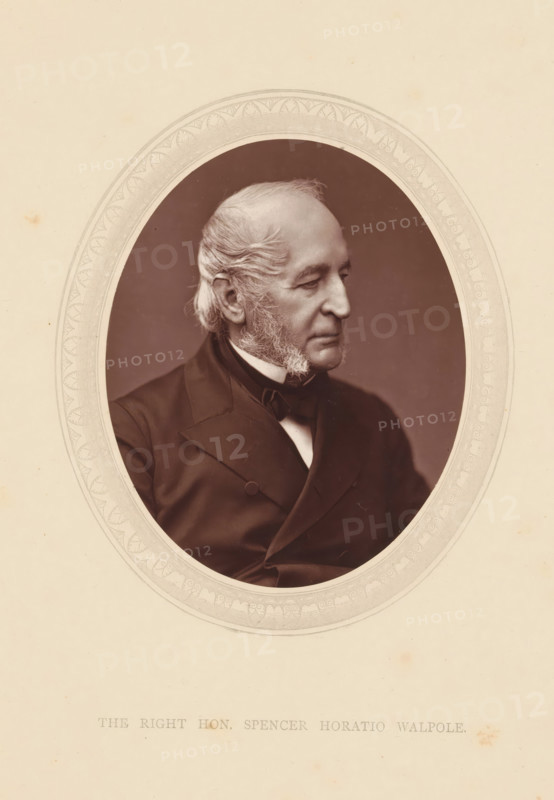 The right hon. Spencer Horatio Walpole, page, photomechanical print, photographer: Lock & Whitfield, cliché maker: anonymous, c. 1871 - in or before 1876, paper, Woodburytype, height 115 mm x width 89 mm, Person, Spencer Horatio Walpole, politician, eg party leader, historical persons (portraits and scenes from the life) ((full) bust portrait), An oval sepia-toned portrait of an older man shown in three-quarter profile facing right, framed by an ornate decorative border, with the man wearing a dark suit jacket, waistcoat, and bow tie, his hair swept back and sideburns visible, set against a plain darker background and surrounded by a light beige mat with subtle spots and marks.