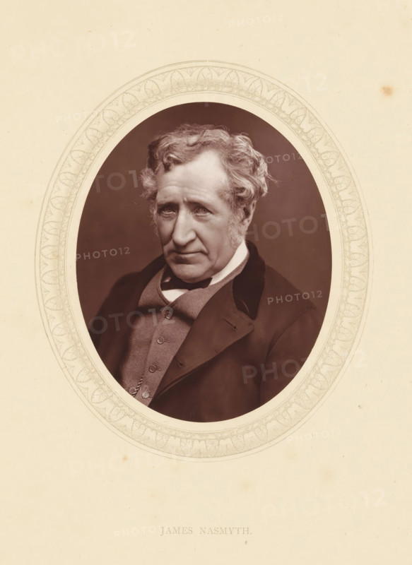 James Nasmyth, page, photomechanical print, photographer: Lock & Whitfield, cliché maker: anonymous, c. 1871 - in or before 1876, paper, Woodburytype, Woodbury Process, height 115 mm x width 89 mm, Person, engineering, historical persons (portraits and scenes from the life) ((full) bust portrait), An oval portrait of an older man with wavy light hair and sideburns set against a dark background, the man wearing a dark coat with a velvet collar over a buttoned waistcoat and a white shirt collar visible, his expression neutral with slightly downturned lips and direct gaze, the oval photograph surrounded by an ornate patterned border on a light paper background.