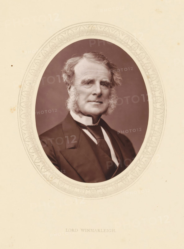 Lord Winmarleigh, page, photomechanical print, photographer: Lock & Whitfield, cliché maker: anonymous, c. 1871 - in or before 1876, paper, Woodburytype, Woodbury Process, height 115 mm x width 89 mm, Person, John Wilson-Patten, politician, eg party leader, historical persons (portraits and scenes from the life) ((full) bust portrait), An oval-framed sepia portrait of an older man with swept-back hair and prominent sideburns, wearing a dark suit jacket, waistcoat, high-collar shirt, and a dark necktie, set against a plain background and surrounded by a decorative patterned border on a creamy sheet.