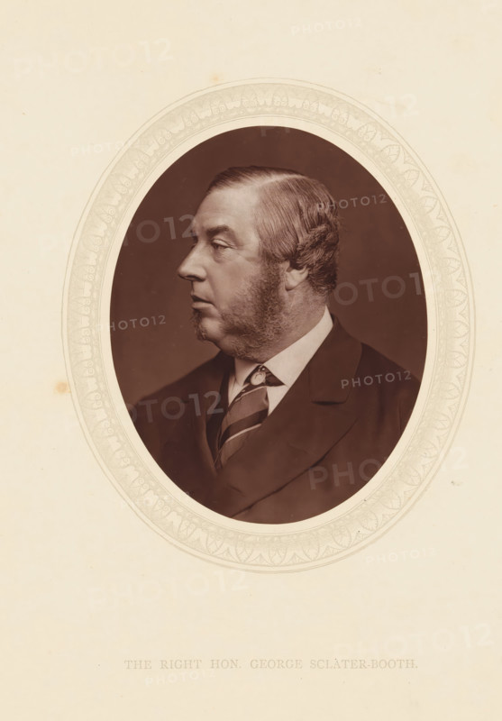 The right hon. George Sclater-Booth, page, photomechanical print, photographer: Lock & Whitfield, cliché maker: anonymous, c. 1873 - in or before 1878, paper, Woodburytype, Woodbury Process, height 115 mm x width 89 mm, Person, George Sclater-Booth, politician, eg party leader, historical persons (portraits and scenes from the life) ((full) bust portrait), A sepia-toned oval portrait of a middle-aged man shown in profile facing left, with neatly combed hair and prominent sideburns, wearing a dark suit jacket, a collared shirt, and a patterned necktie, set against a dark background within a decorative light-colored oval mat on a pale textured paper.