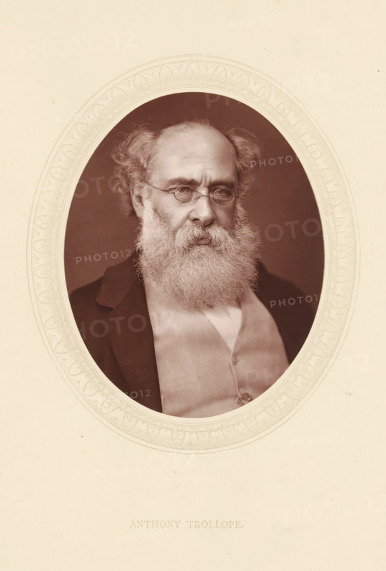 Anthony Trollope, page, photomechanical print, photographer: Lock & Whitfield, cliché maker: anonymous, c. 1873 - in or before 1878, paper, Woodburytype, Woodbury Process, height 115 mm x width 89 mm, Person, portrait of a writer, historical persons (portraits and scenes from the life) ((full) bust portrait), An oval portrait set within a decorative border shows an older man with a full, bushy beard and mustache and thinning hair at the crown, wearing round spectacles and a dark jacket over a light waistcoat and shirt, his expression neutral and his gaze slightly off center.