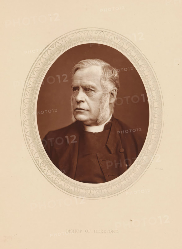Bishop of Hereford, page, photomechanical print, photographer: Lock & Whitfield, cliché maker: anonymous, c. 1873 - in or before 1878, paper, Woodburytype, Woodbury Process, height 115 mm x width 89 mm, Person, James Atlay, archbishop, bishop, etc. (Roman Catholic), historical persons (portraits and scenes from the life) ((full) bust portrait), An oval-framed sepia portrait of an older man shown from the chest up, facing slightly to his right, with light-colored hair combed back and prominent sideburns, a high-collared garment visible at his neck and a dark coat with a button and lapel, set against a plain dark background and surrounded by a decorative patterned oval border on a light beige paper.