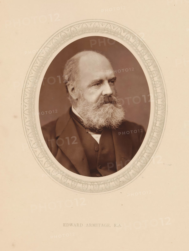 Edward Armitage, RA, page, photomechanical print, photographer: Lock & Whitfield, cliché maker: anonymous, c. 1873 - in or before 1878, paper, Woodburytype, Woodbury Process, height 115 mm x width 89 mm, Person, portrait, self-portrait of painter, historical persons (portraits and scenes from the life) ((full) bust portrait), An oval sepia portrait of an older man with a full beard and mustache, receding hairline, and a contemplative expression, dressed in a dark suit jacket and waistcoat with a visible shirt collar, set against a plain darker oval background and surrounded by an ornate decorative border on a light-colored sheet.