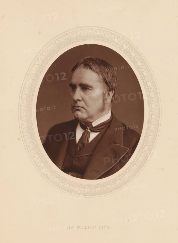 Sir William Gull, page, photomechanical print, photographer: Lock & Whitfield, cliché maker: anonymous, c. 1873 - in or before 1878, paper, Woodburytype, Woodbury Process, height 115 mm x width 89 mm, Person, William Gull, physician, doctor, historical persons (portraits and scenes from the life) ((full) bust portrait), An oval photographic portrait of a middle-aged man with short neatly combed hair and sideburns set against a dark background, the man wearing a dark suit jacket over a waistcoat and a necktie with a visible collar, the portrait surrounded by a decorative oval border on a pale textured background.