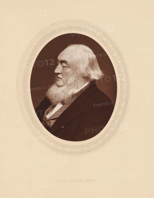 Lord justice James, page, photomechanical print, photographer: Lock & Whitfield, cliché maker: anonymous, c. 1875 - in or before 1880, paper, Woodburytype, Woodbury Process, height 115 mm x width 89 mm, Person, William Milbourne James, magistracy, judges, historical persons (portraits and scenes from the life) ((full) bust portrait), An oval sepia portrait shows an older man in profile facing left with a full white beard and longer white hair at the sides, wearing a dark coat over a textured waistcoat and a light collar, set against a dark background and surrounded by a decorative oval border on a pale page.