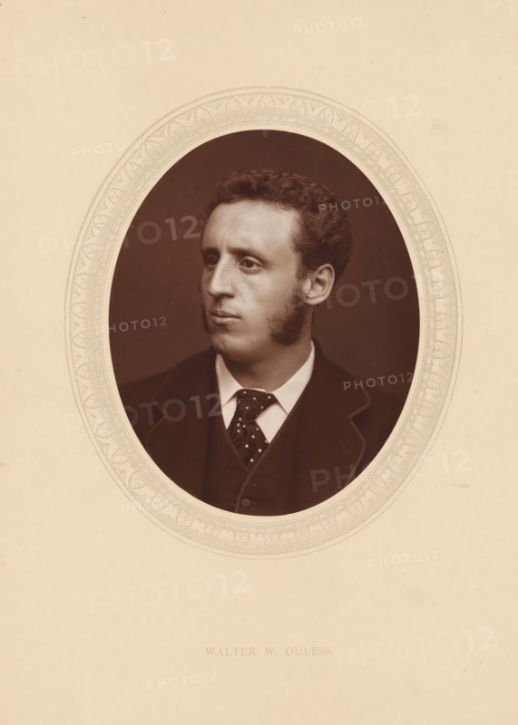 Walter W. Ouless, page, photomechanical print, photographer: Lock & Whitfield, cliché maker: anonymous, c. 1875 - in or before 1880, paper, Woodburytype, Woodbury Process, height 115 mm x width 89 mm, Person, Walter William Ouless, portrait, self-portrait of painter, historical persons (portraits and scenes from the life) ((full) bust portrait), A sepia oval portrait of a man with short curly hair and prominent sideburns, shown from the chest up and turned slightly to his left, wearing a dark jacket over a vest and a patterned tie with a white shirt collar, set against a dark background and framed by a decorative oval border on a light beige mount.