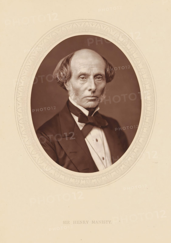 Sir Henry Manisty, page, photomechanical print, photographer: Lock & Whitfield, cliché maker: anonymous, c. 1875 - in or before 1880, paper, Woodburytype, Woodbury Process, height 115 mm x width 89 mm, Person, Henry Manisty, magistracy, judges, historical persons (portraits and scenes from the life) ((full) bust portrait), A sepia-toned oval portrait of an older man with a high forehead and receding hairline, flanked by short wavy hair and sideburns, wearing a dark formal jacket with wide lapels, a white shirt with a high collar, and a dark bow tied at the neck, set against a plain dark background and surrounded by a decorative oval border on a light paper background.