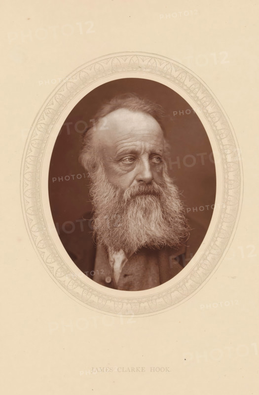 James Clarke Hook, page, photomechanical print, photographer: Lock & Whitfield, cliché maker: anonymous, c. 1875 - in or before 1880, paper, Woodburytype, Woodbury Process, height 115 mm x width 89 mm, Person, portrait, self-portrait of painter, historical persons (portraits and scenes from the life) ((full) bust portrait), An oval sepia photograph of an older man with a full long beard and mustache, receding hairline, and visible facial wrinkles, shown from the shoulders up and turned slightly to his right, set within a decorative oval border on a light beige background.