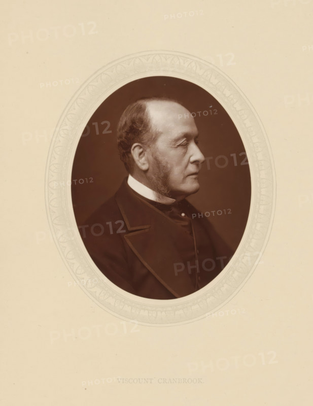 Viscount Cranbrook, GCSI, page, photomechanical print, photographer: Lock & Whitfield, cliché maker: anonymous, c. 1876 - in or before 1881, paper, Woodburytype, Woodbury Process, height 115 mm x width 89 mm, Person, Gathorne Gathorne-Hardy, politician, eg party leader, historical persons (portraits and scenes from the life) ((full) bust portrait), An oval sepia photograph of an older man in profile set against a dark background and framed by a decorative light-colored border, showing his side view with short hair and sideburns, a high collar and dark coat with lapels, and a neutral facial expression.