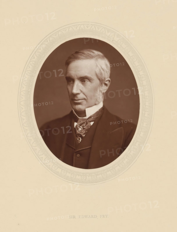 Sir Edward Fry, page, photomechanical print, photographer: Lock & Whitfield, cliché maker: anonymous, c. 1876 - in or before 1881, paper, Woodburytype, Woodbury Process, height 115 mm x width 89 mm, Person, Edward Fry, magistracy, judges, historical persons (portraits and scenes from the life) ((full) bust portrait), A sepia-toned oval portrait of a middle-aged man with light-colored hair combed to the side and prominent sideburns, wearing a dark suit jacket, waistcoat, and a patterned cravat with a high white collar, set against a plain darker background and surrounded by a pale decorative oval mat on a light beige page.