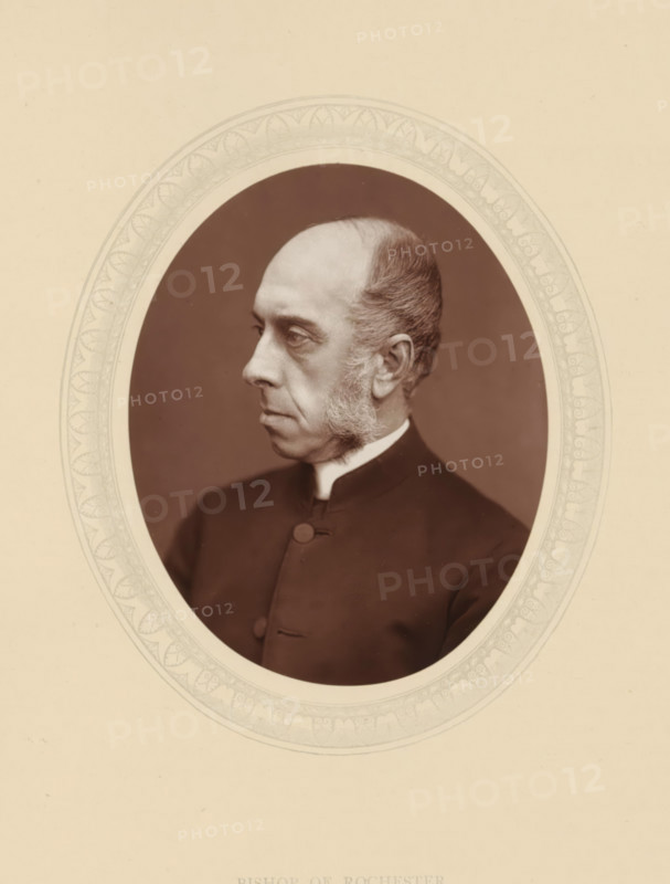 Bishop of Rochester, page, photomechanical print, photographer: Lock & Whitfield, cliché maker: anonymous, c. 1876 - in or before 1881, paper, Woodburytype, Woodbury Process, height 115 mm x width 89 mm, Person, Anthony Thorold, functions and dignitaries, episcopal Protestant churches, historical persons (portraits and scenes from the life) ((full) bust portrait), An oval sepia portrait of a middle-aged man shown in profile facing left, with a high forehead and receding hair, sideburns, and a clean-shaven jaw, wearing a dark buttoned coat with a visible collar, set against a dark oval background surrounded by a decorative pale border and mounted on a light beige mat.