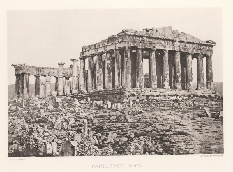 Parthénon nord, Parthenon on the Acropolis of Athens, page, photomechanical print, Athens, cliché maker: Dujardin, printer (person): Chardon-Wittmann, c. 1880 - in or before 1890, photographer, printer (person), Athene, Periféreia Protevoúsis, paper, photoaquatint, height 145 mm x width 215 mm, ruin of a building, architecture, temple, shrine, Greek religion, Acropolis, Parthenon, A wide sepia-toned photograph of an ancient stone temple ruin with a row of tall fluted columns supporting a partially intact entablature and pediment, set on a stepped platform surrounded by scattered broken stones and fragments across uneven rocky ground, with additional shorter columns visible to the left and an open sky above.