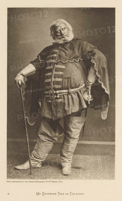 Herbert Beerbohm Tree as Falstaff, page, photomechanical print, photographer: London Stereoscopic Company, cliché maker: anonymous, c. 1883 - in or before 1893, paper, photoaquatint, height 216 mm x width 137 mm, Person, Herbert Beerbohm Tree, portrait of actor, actress, A sepia-toned portrait of a man standing full-length wearing a heavy costume with a wide scalloped cape and padded tunic, a wide belt with visible fastenings, loose knee-high boots, and a curly full beard and hair; he rests one hand on a slender cane and the other hand on his hip holding a small ridden object, his legs are slightly apart with one knee bent, and the background is plain and evenly shaded.