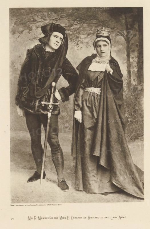 Mr R. Mansfield and Miss B. Cameron as Richard III and Lady Anne, page, photomechanical print, photographer: London Stereoscopic Company, cliché maker: anonymous, c. 1883 - in or before 1893, paper, photoaquatint, height 215 mm x width 147 mm, Person, Richard Mansfield, Beatrice Cameron, portrait of actor, actress, A sepia-toned photograph of two people in historical costume standing side by side against a painted backdrop with trees; on the left a person wearing dark fitted hose and shoes, a fur-trimmed tunic, a long draped hooded headpiece, and holding a long sword vertically with one hand resting on the hilt while looking slightly toward the right; on the right a person wearing a long flowing gown and cloak, a head covering with a crown, a decorative belt, and a white collar detail, holding part of the cloak with one hand and looking forward with a neutral expression.
