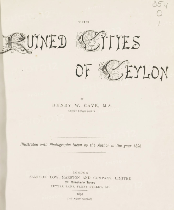 The ruined cities of Ceylon, book, name: 'J. Hanley Power', writer (clerical worker): Henry William Cave, publisher: Sampson Low, Marston & Company, London, 1897, writer (clerical worker), textile materials, pasteboard, paper, linen (material), printing, Woodbury engraving, color on cut, Woodbury engraving and color on cut, height 285 mm x width 225 mm x thickness 33 mm, A light-colored page with ornate decorative lettering across the top center and left, a pair of large ornate initials with swirling leaf-like embellishments, smaller plain characters between and below them, a short horizontal rule near the middle, a faint vertical smudge near the left edge, a narrow darker strip along the left margin, a few small scattered brown spots on the paper, and light printed lines and small printed blocks of text near the lower half of the page.