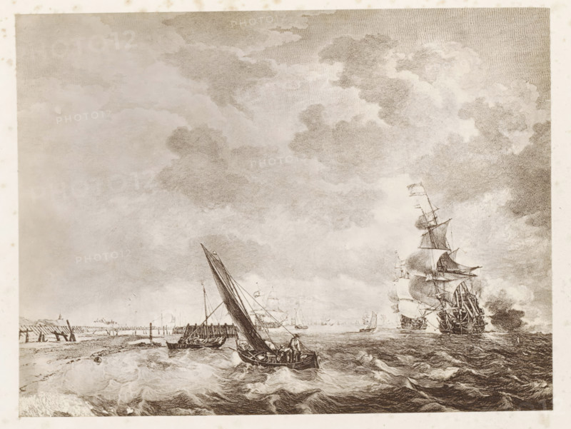 Photo reproduction of a print after a painting, depicting ships at sea, photograph, reproduction, page, after print by anonymous, after painting by Ludolf Bakhuysen, c. 1859 - in or before 1869, photographer, after print by, paper, albumen print, height 125 mm x width 170 mm, ships (in general), sea, A monochrome scene showing a coastal seascape with expansive cloud-filled sky above a choppy sea, boats and ships on the water, a smaller sailboat in the foreground with figures aboard and a larger multi-masted ship with furled and billowing sails further out, a low shoreline with wooden piers and posts along the left side, waves breaking near the shore, and finely detailed etching-style lines throughout the image.