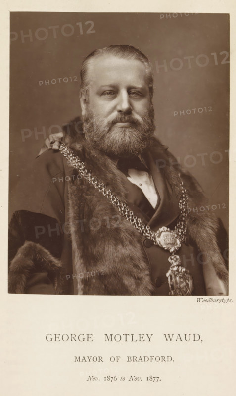 Portrait of George Motley Waud, George Motley Waud, mayor of Bradford, page, photomechanical print, inscription: 'Nov. 1876 to Nov. 1877.', photographer: Appleton & Co., Bradford (England), cliché maker: anonymous, c. 1871 - in or before 1881, paper, Woodburytype, Woodburytypepie, height 116 mm x width 91 mm, historical persons (portraits and scenes from the life) ((full) bust portrait), A sepia portrait of a bearded man shown from the chest up wearing a dark formal coat with a fur collar and an ornate chain of office draped across his chest, his hair is neatly combed back and he gazes directly at the camera with a neutral expression against a plain background.