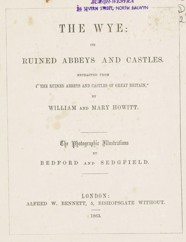 The Wye its ruined abbeys and castles, book, name: 'Walch and Son Bookseller Hobart Town', name: 'Kenneth Coc Burgh-Westra 26 Severn Street, North Balwyn', inscription: 'A parting gift to Eby from Marion Muller 'The lord be with thee'', writer (clerical worker): William Howitt, writer (clerical worker): Mary Howitt, publisher: Alfred William Bennett, London, 1863, writer (clerical worker), textile materials, paper, linen (material), albumen print, color on cut, height 189 mm x width 143 mm x thickness 10 mm, A cream-colored page with a thin rectangular border containing centered printed headings in various serif fonts, some larger and bolder, and some ornate; there are small brownish age spots and faint stains scattered across the paper; a purple oval stamp and purple handwritten mark appear near the top edge; a faint embossed circular seal is visible near the top right; horizontal rules separate some sections; overall the layout shows multiple lines of centered typographic elements wi...