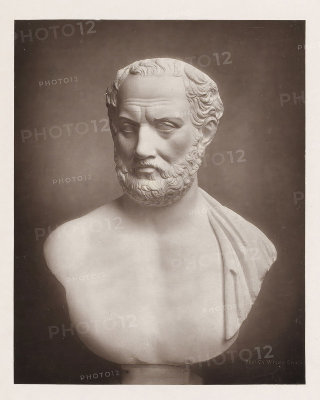 Portrait bust of Thucydides, page, photomechanical print, photographer: Charles David Winter, cliché maker: anonymous, c. 1868 - in or before 1878, paper, carbon print, height 184 mm x width 145 mm, sculpture, chest, bust, A photographic image of a marble bust showing the head and upper torso of a bearded male figure with short wavy hair and a draped garment over one shoulder, set against a dark background.