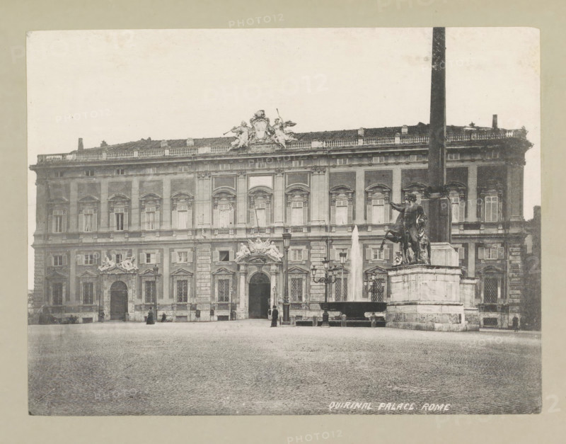 Quirinal palace, Rome, page, photomechanical print, photographer: Samuel J. Beckett, Quirinal, c. 1890 - c. 1900, Quirinaal, paper, collotype, photoprint, height 152 mm x width 202 mm, façade (or house or building), hôtel, ie small palace in city, Palazzo del Quirinale, A wide facade of a multi-story stone building with rows of tall windows and decorative arches and columns stretches across the scene, topped by a balustraded roofline with sculptural figures and cresting at the center; in front of the building a paved open square extends across the foreground, with a raised fountain basin jetting a vertical spray and a large stone pedestal supporting an equestrian statue of a mounted figure; lampposts and smaller statues flank the fountain area, and a few small human figures stand or walk near the building entrances.