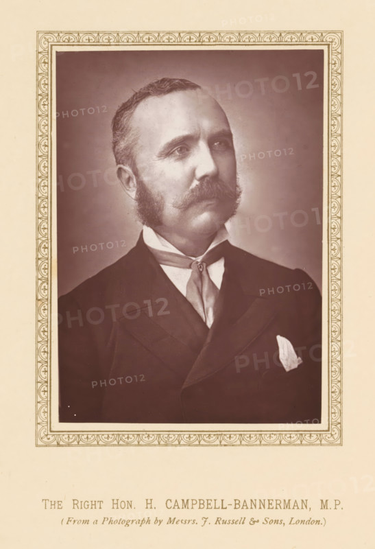 The right hon. H. Campbell-Bannerman, MP, page, photomechanical print, photographer: Russell & Sons, London, c. 1875 - c. 1880, printmaker, paper, Woodburytype, height 118 mm x width 83 mm, Person, Henry Campbell-Bannerman, politician, eg party leader, A sepia-toned portrait of a man shown from the chest up, framed by a decorative rectangular border with repeating ornamental motifs; the man has short hair and prominent sideburns connected to a thick mustache, a high-collared shirt with a cravat tied at the neck, a dark suit jacket with a visible lapel, and a light-colored pocket square; the background inside the frame is plain and slightly shaded, while the surrounding area outside the frame is a light cream color.